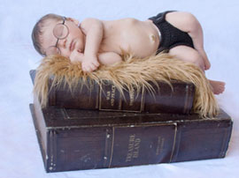 newborn baby as harry potter sleeping on books