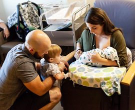 Introducing newborn baby to older brother in the hospital