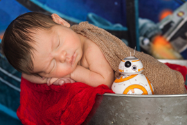 Newborn baby with Star Wars droid BB-8