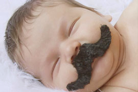 Newborn baby boy with a fake mustache