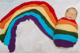 Newborn baby in rainbow wraps